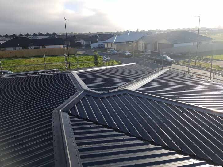 Hip-design long run roofing by Huston Cross