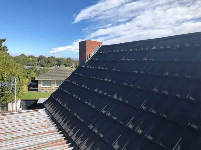 Older Decramastic roof on a Christchurch home, showing why many homeowners replace ageing tiled roofing with long-run metal